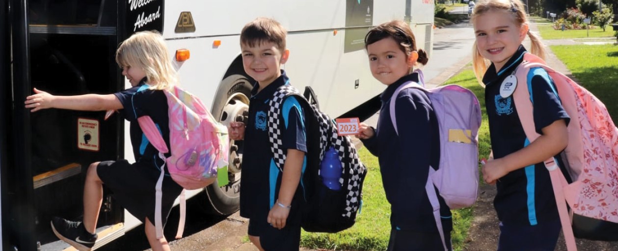 kids getting on the bus with bus pass