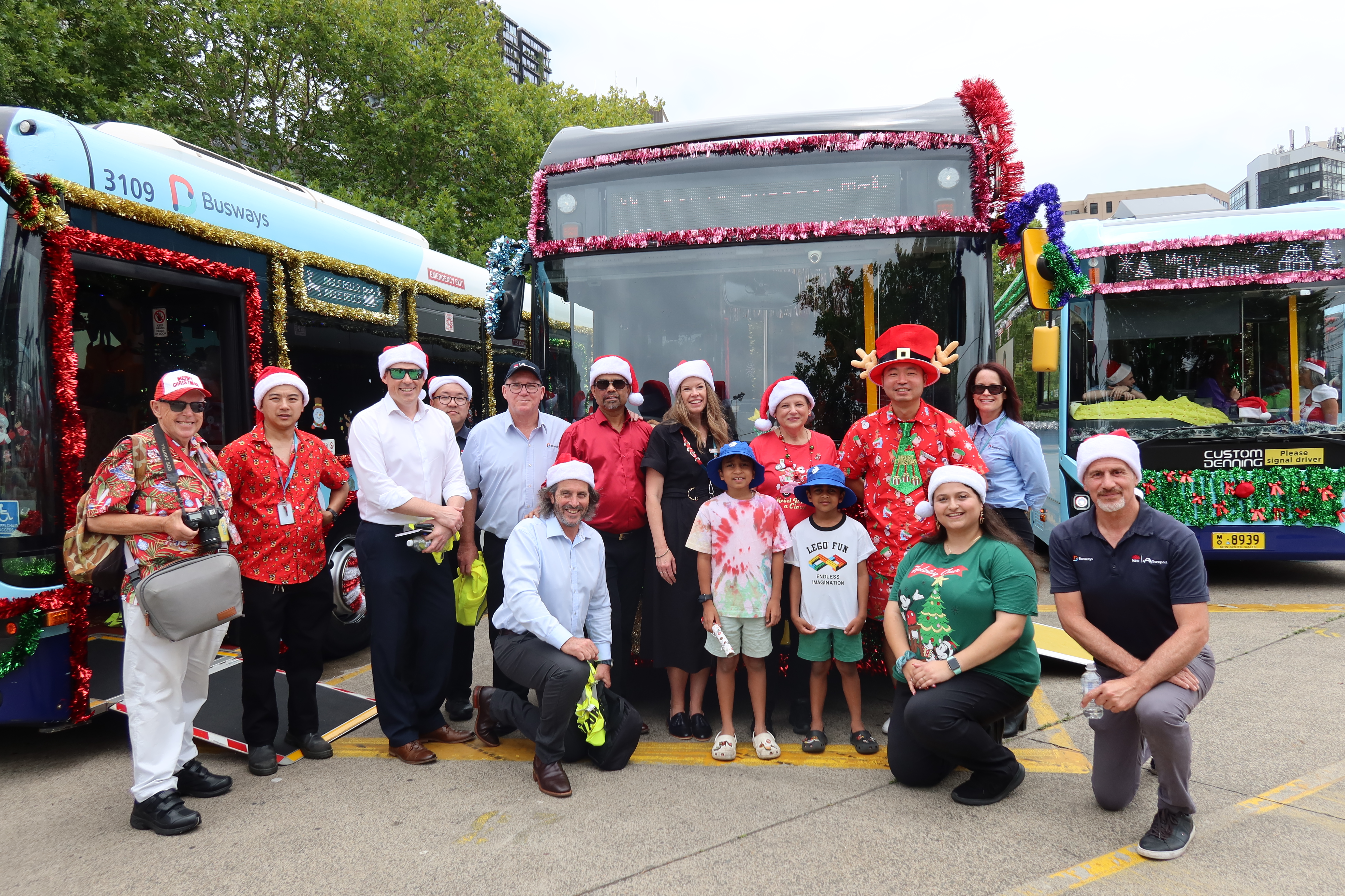 Team photo front of winning Christmas bus 
