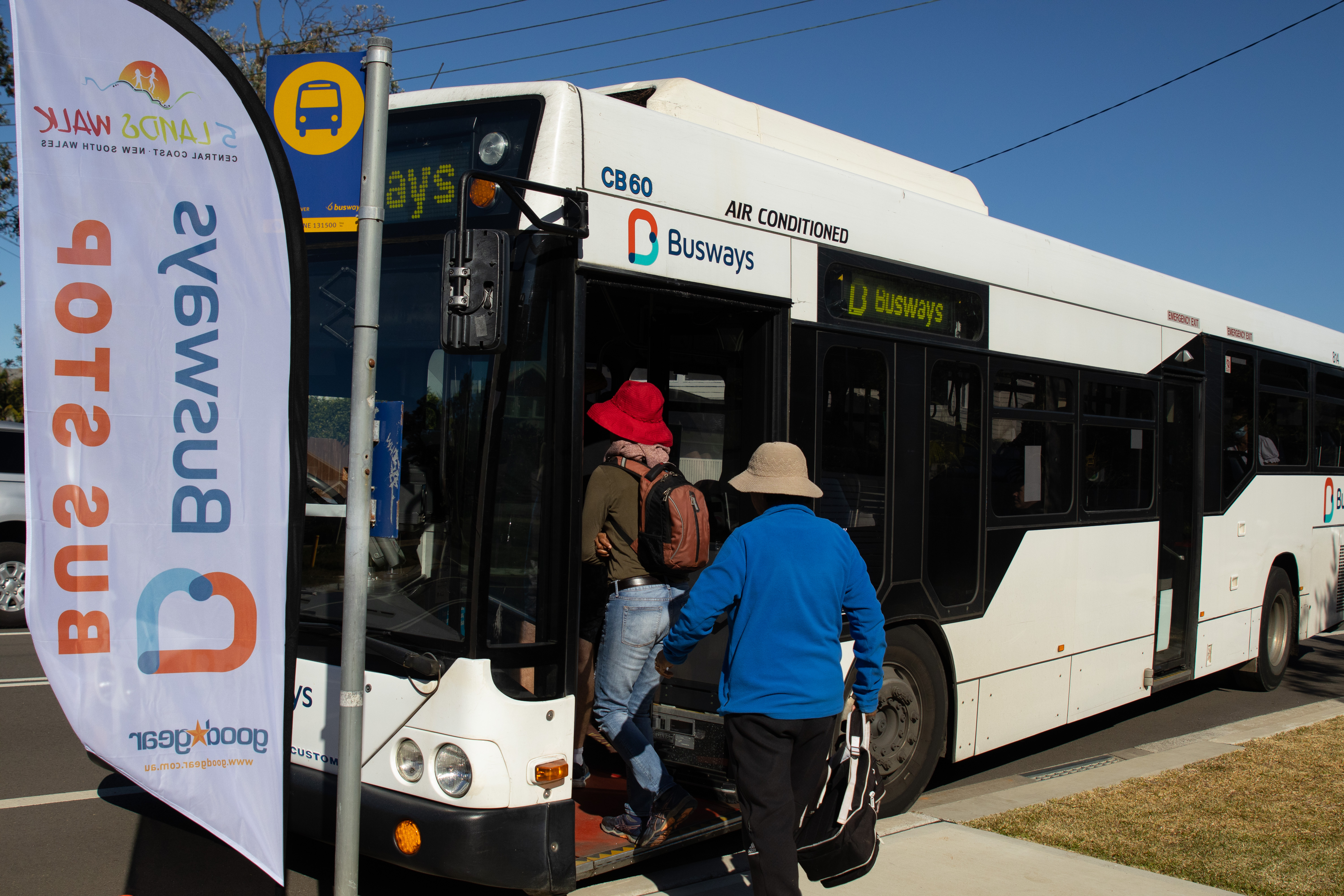 customer boarding Busways bus at community event