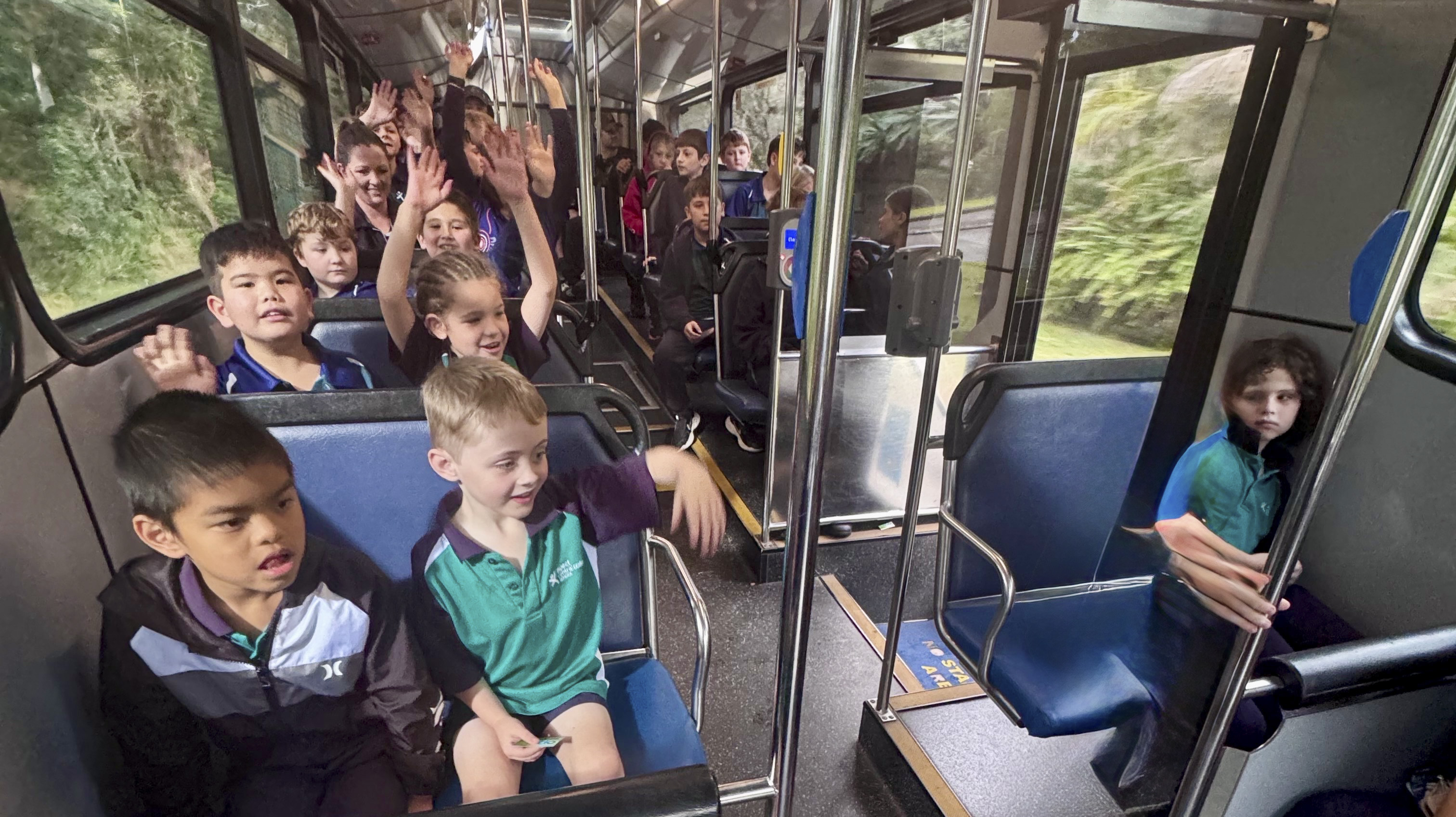 School children riding on a bus as part of our bus education program.