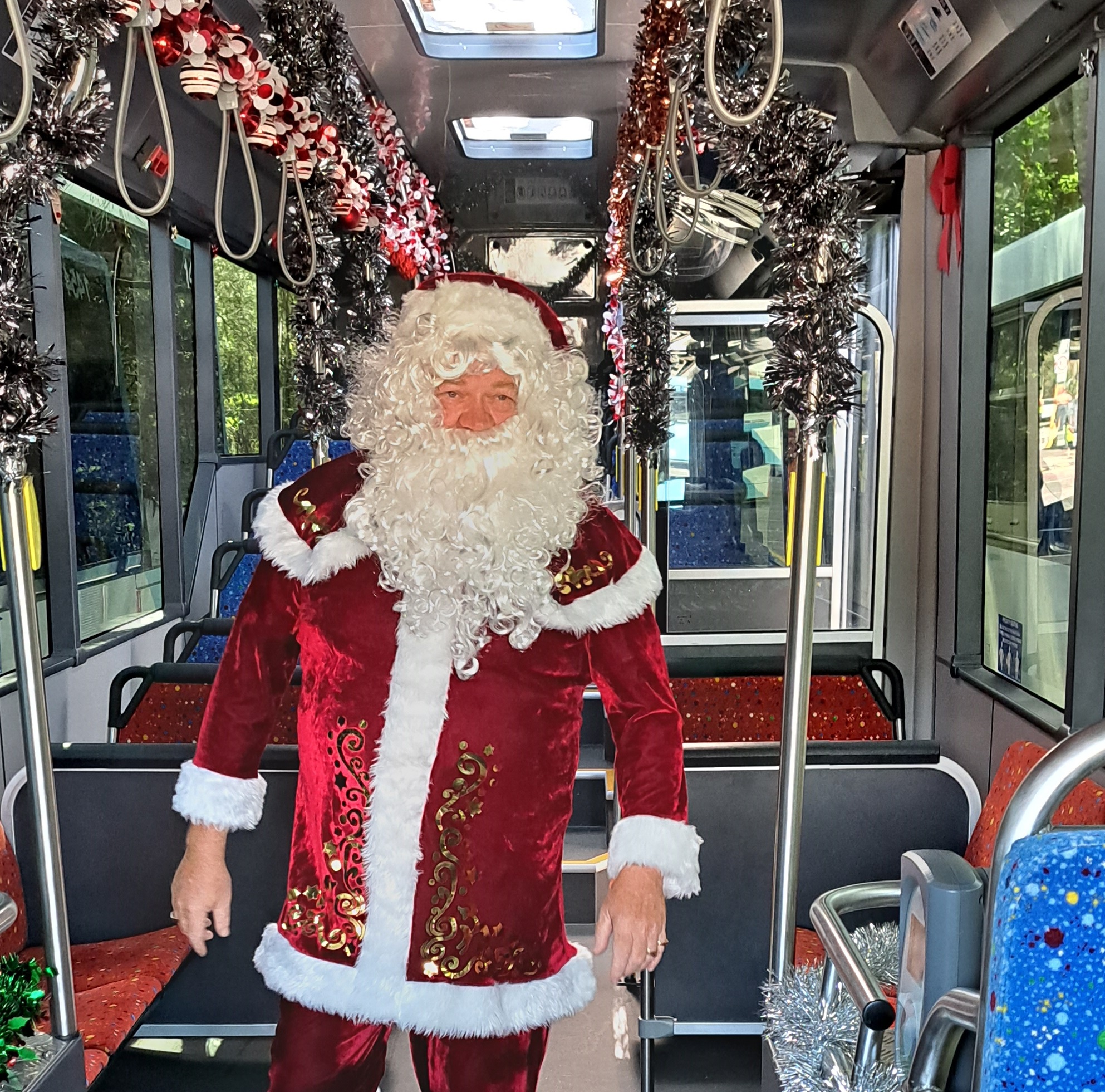Santa on Busways bus walking down aisle 