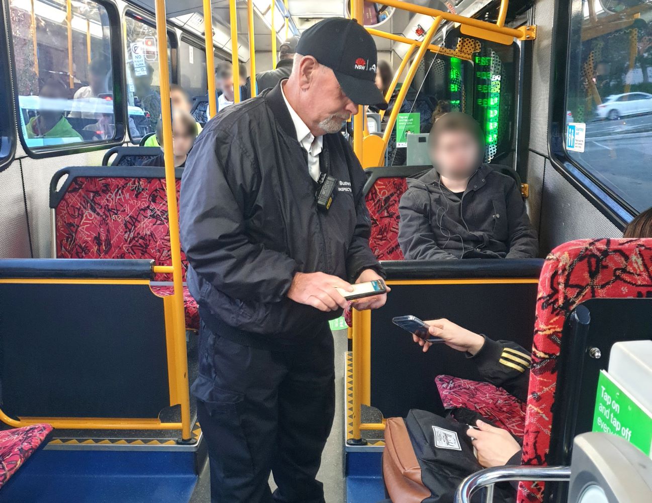 Customer Relations Officer inspecting tickets on board