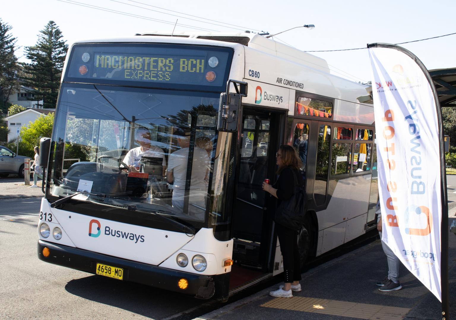 Busways bus picking up passengers from community event