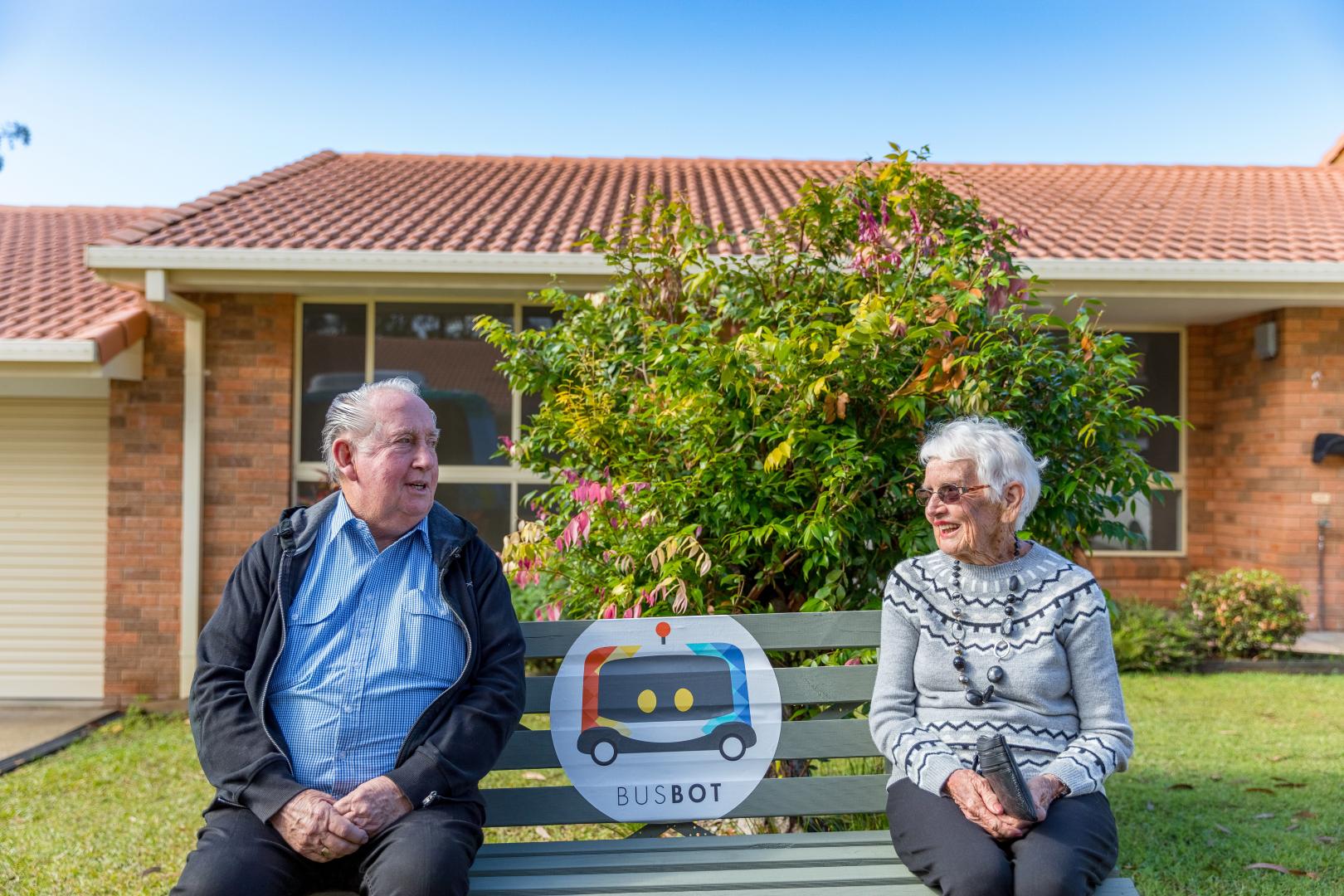 Residents Margaret and Keith enjoying a the sunshine at the BusBot bus stop. Photo: Mitchell Franzi