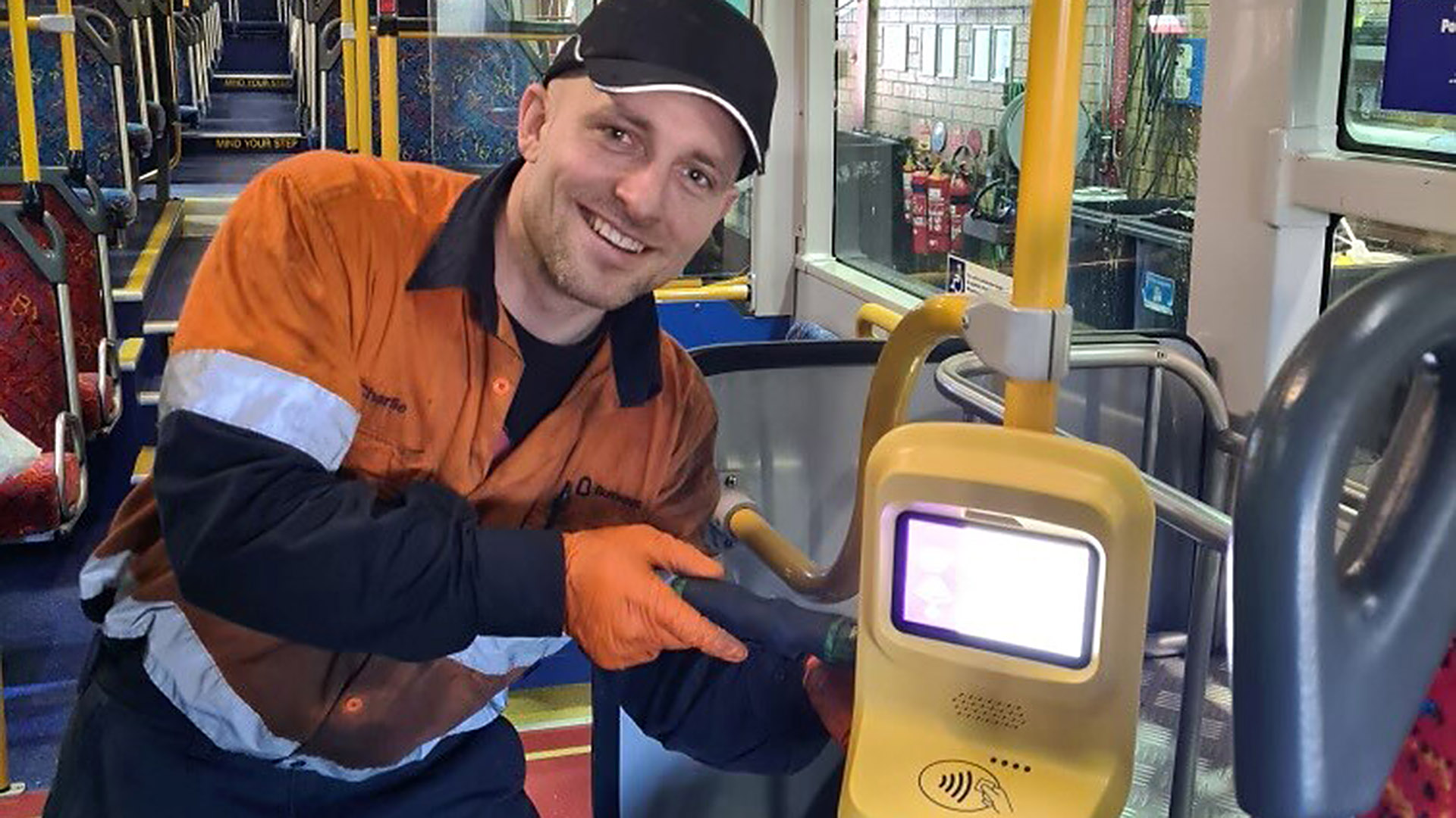 Busways employee shows off validator