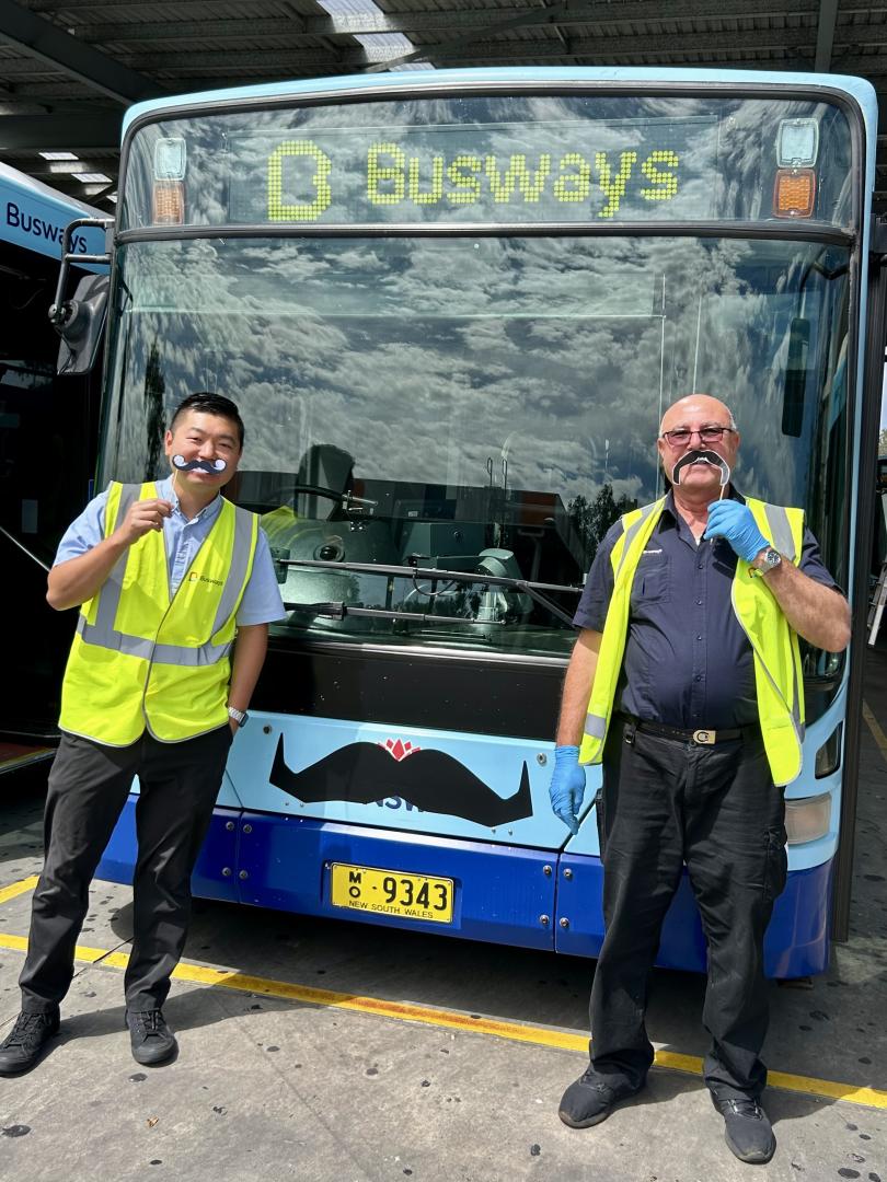 Staff holding movember prop