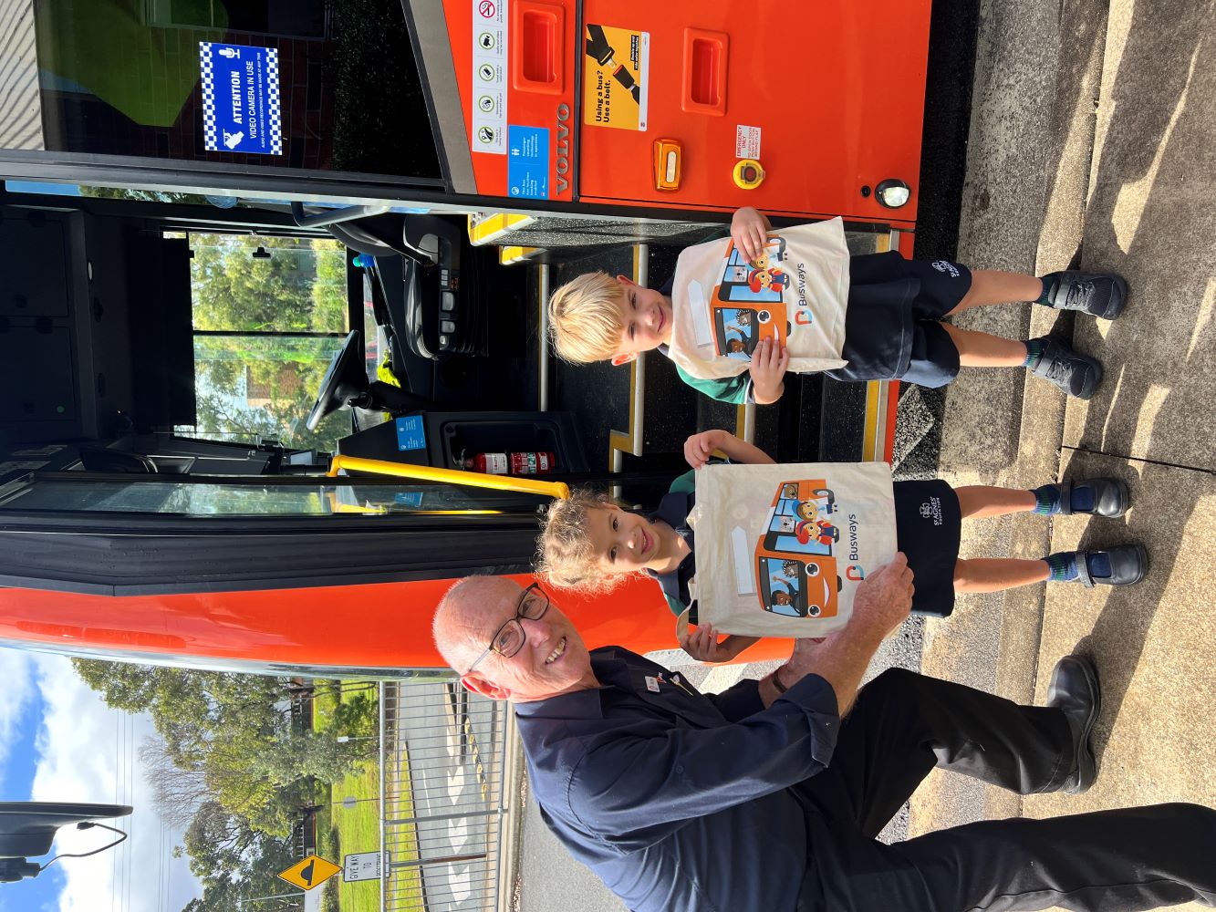Busways educator Murray White presents St Peters Primary School students with bus safety hero gift packs