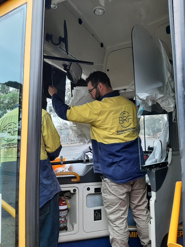 Mechanics installing new screen 