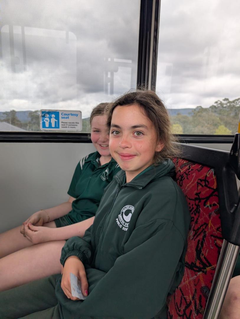 Students smiling while on the practical bus ride component of the bus education program