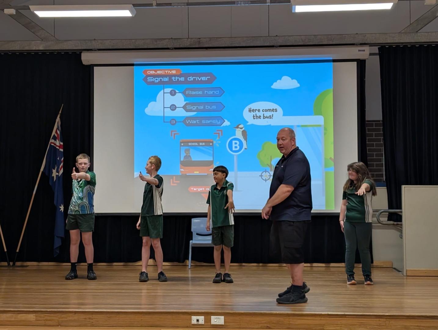 Our bus educator on stage with students during a practical demonstration
