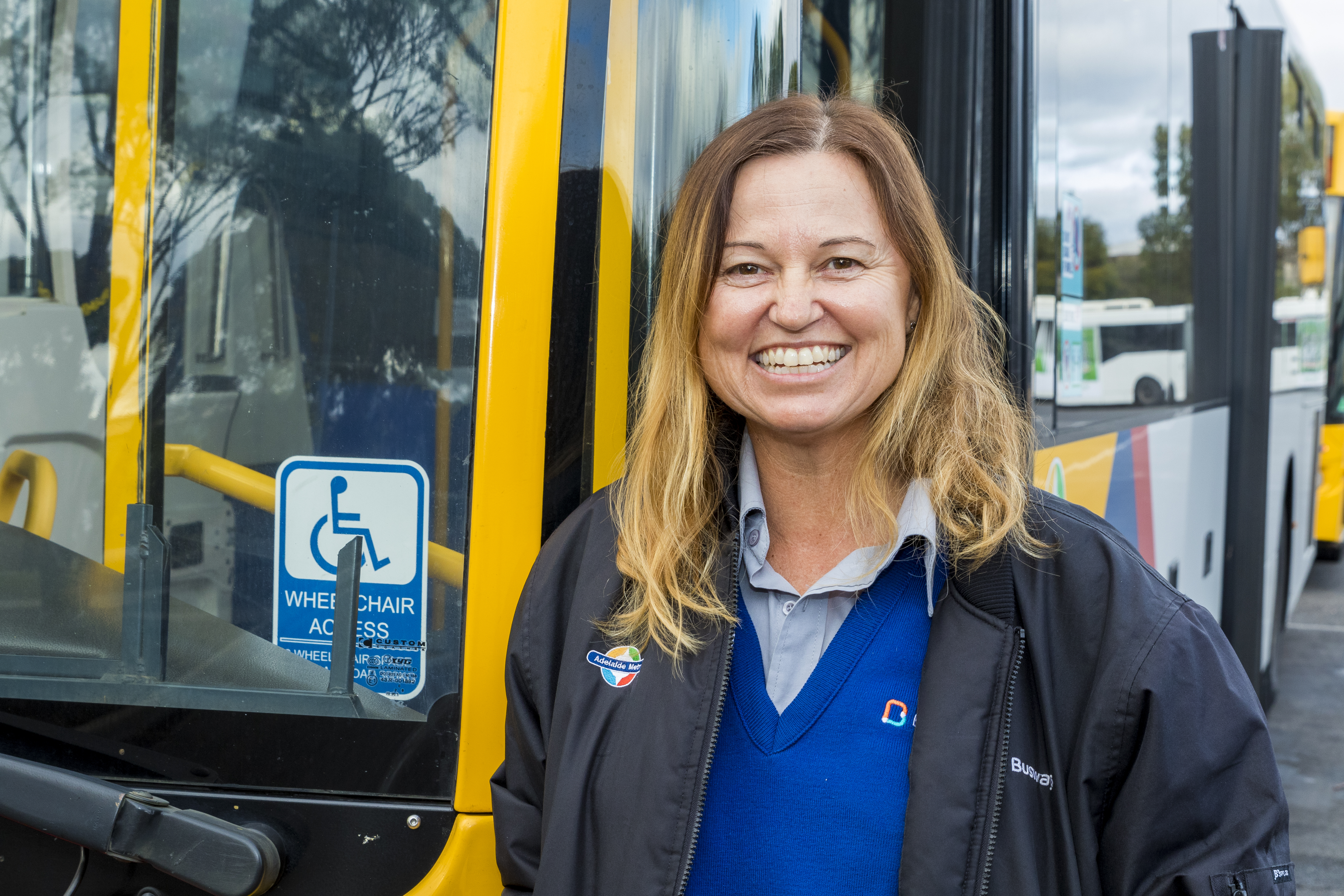 driver-smiling-with-bus